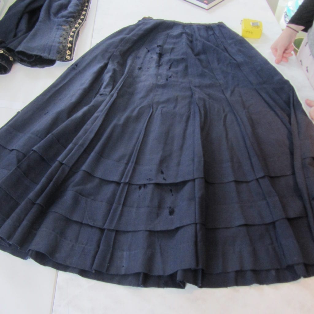 The pleated wool skirt used a large amount of fine fabric, indicating wealth and opulence