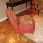 Side view of restored floral needlework slipper chair with gilt frame.