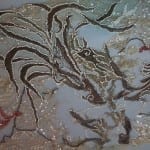 A dragon motif embroidery on a beaded 1920s evening dress before conservation.