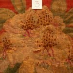 Post-conservation detail labeled "3" showing the previously damaged area of a floral needlework chair seat now in-filled with re-woven tan, gold, and brown wool stitching.