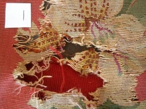 Condition documentation of needlework chair seat area 1, showing severe loss and fraying before conservation.