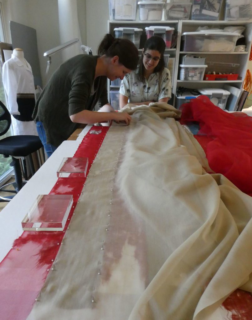 image of old damaged flag being repaired by hand