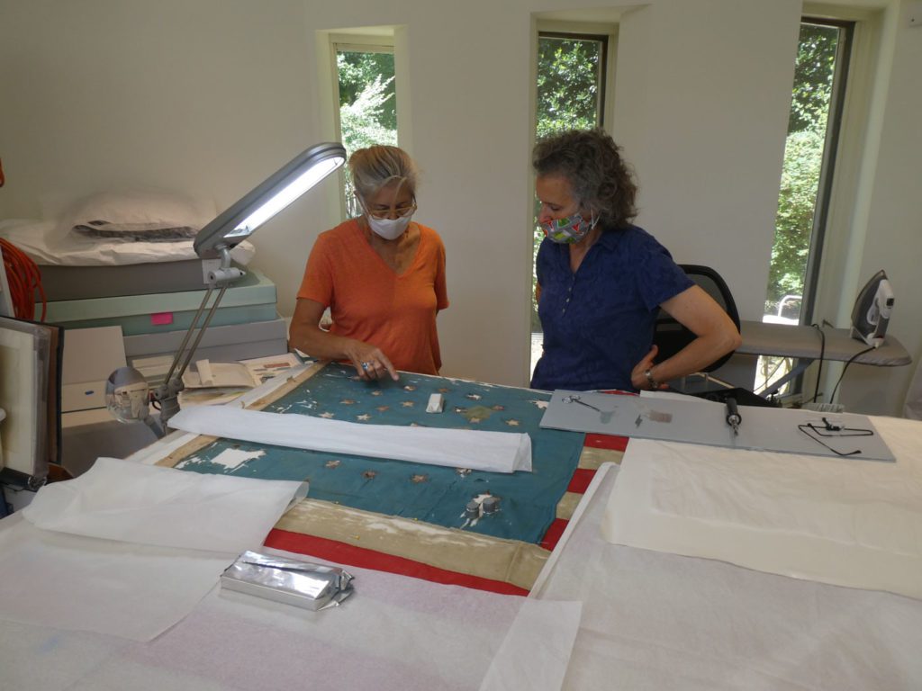 textile professionals Julia and Nancy discuss a repair plan