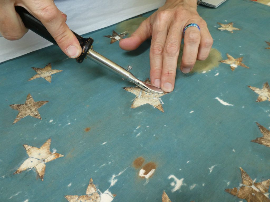 damaged star is repaired with a tacking iron