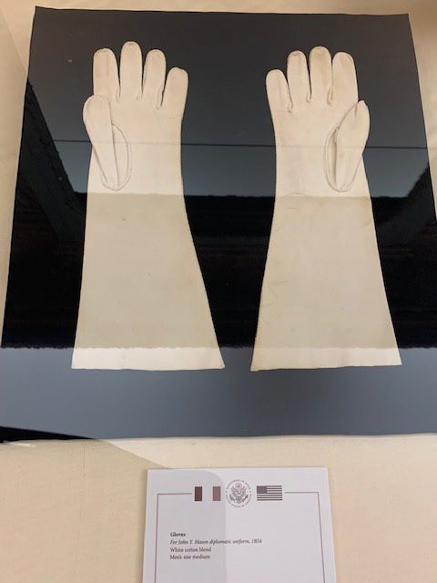 long white dress gloves in glass case