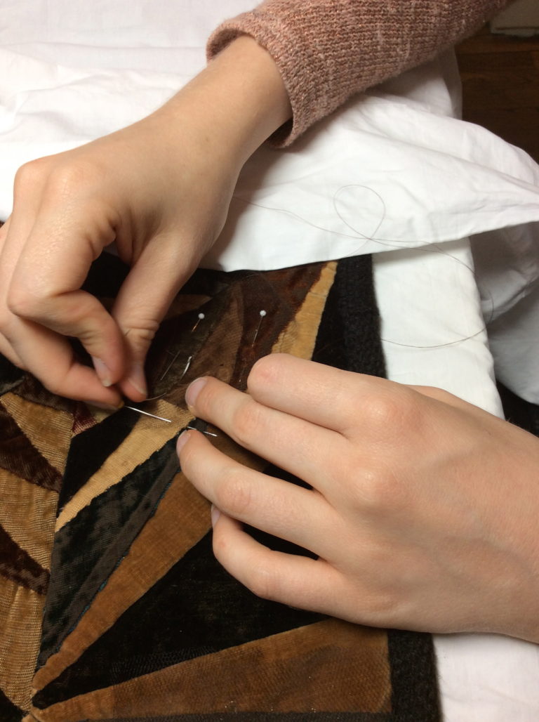 Hands stitching fabric