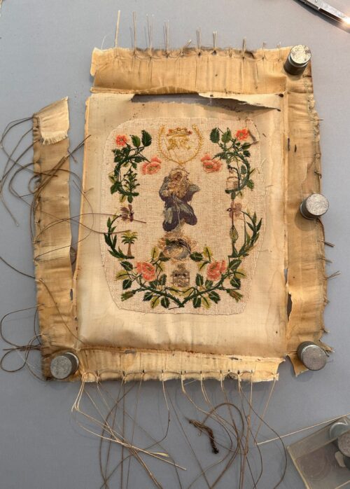 Damaged antique silk embroidery of Mary