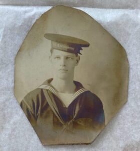Vintaged photo of a young sailor wearing cap of U.S.S. Vermont.